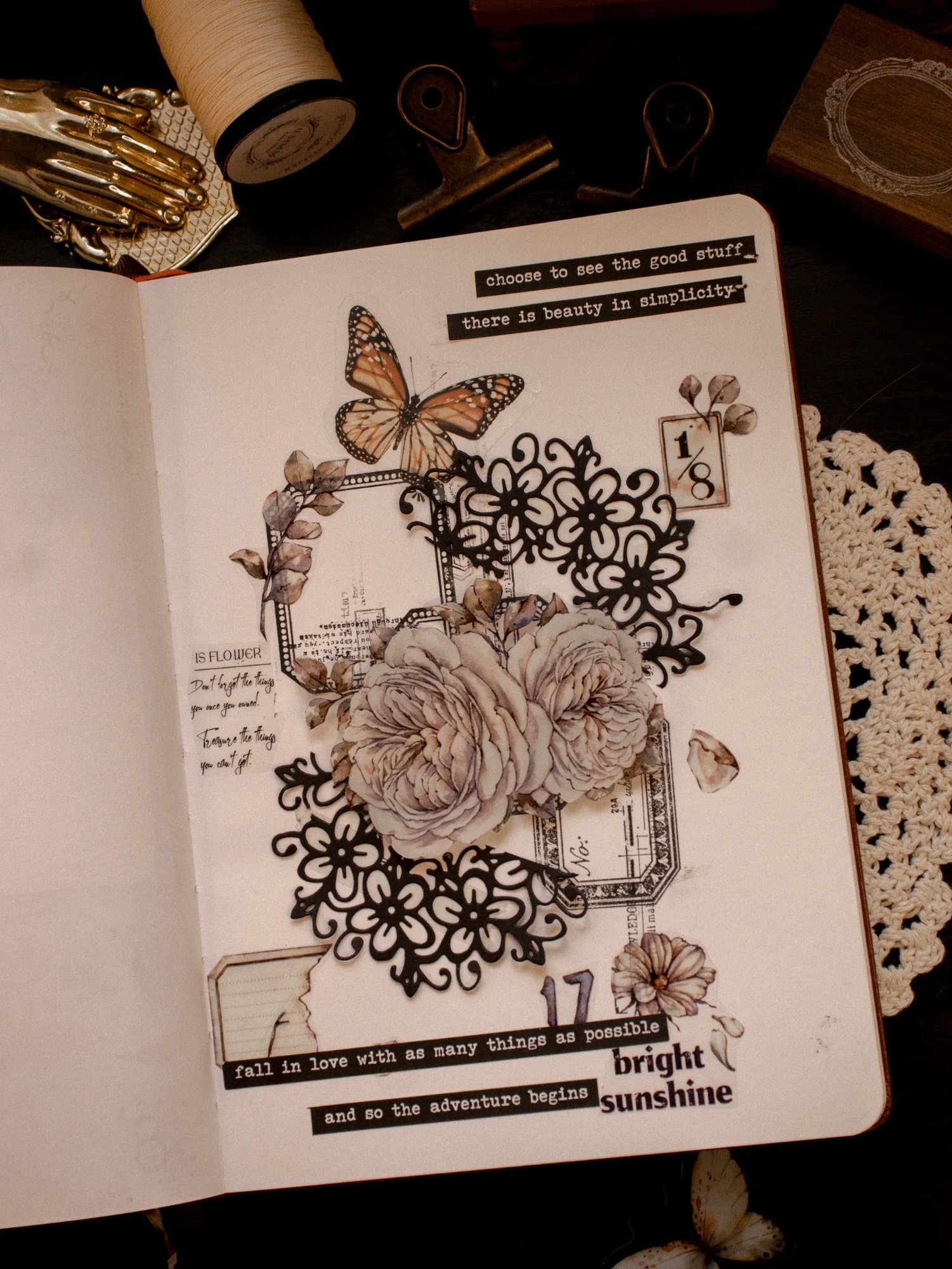A journal page with a drawn face framed by intricate black flowers and fine linework